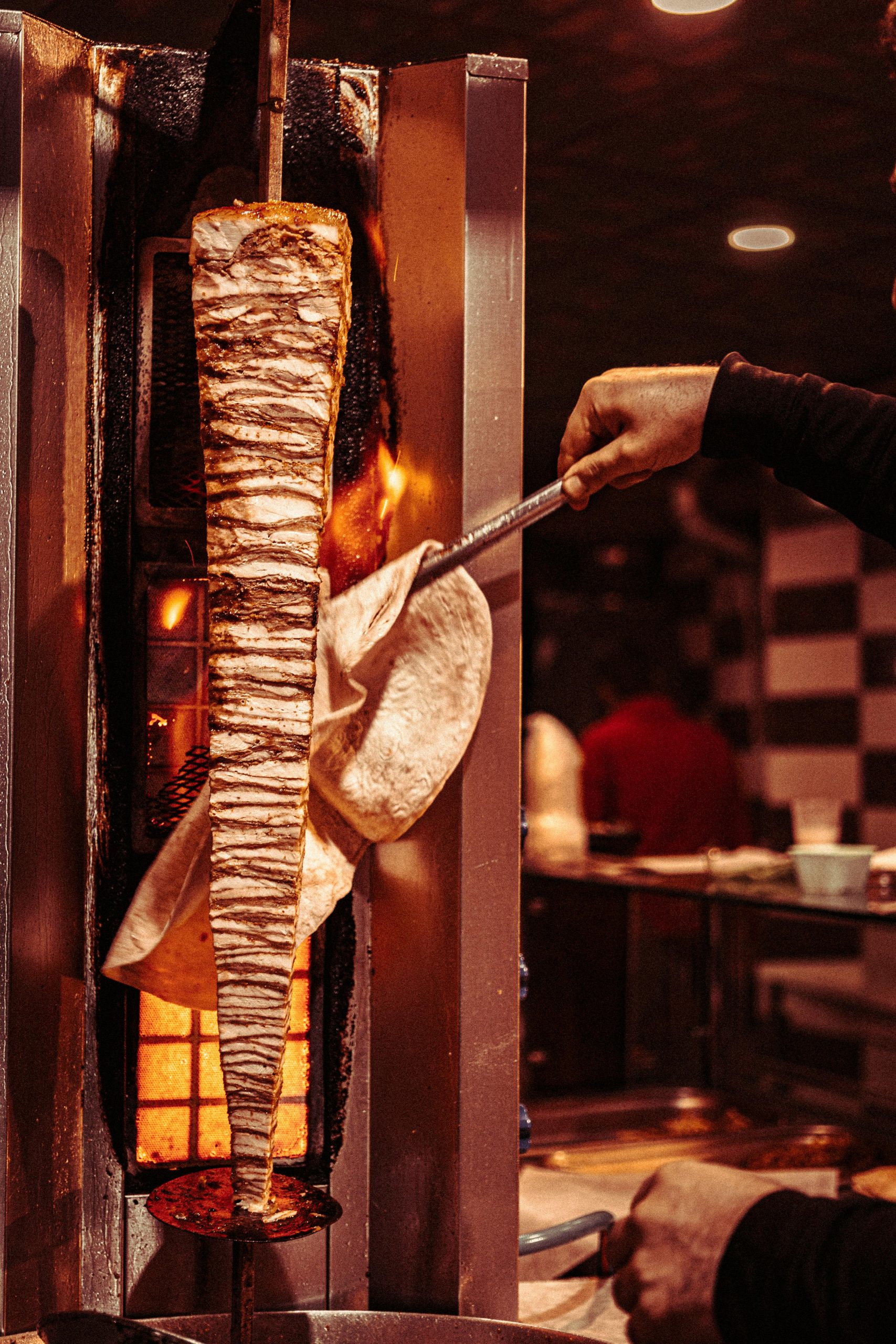 Close-up of shawarma being cooked on a rotisserie in a traditional Gaziantep restaurant.